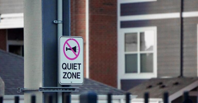 Zoning - A sign on a pole that says quiet zone