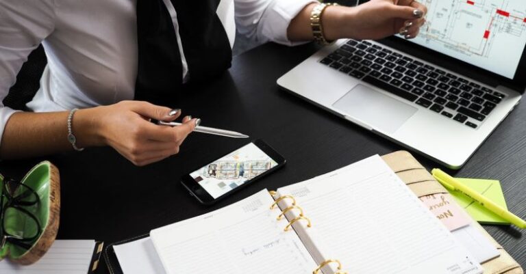 Real Estate - Person Pointing on the Screen of a Laptop