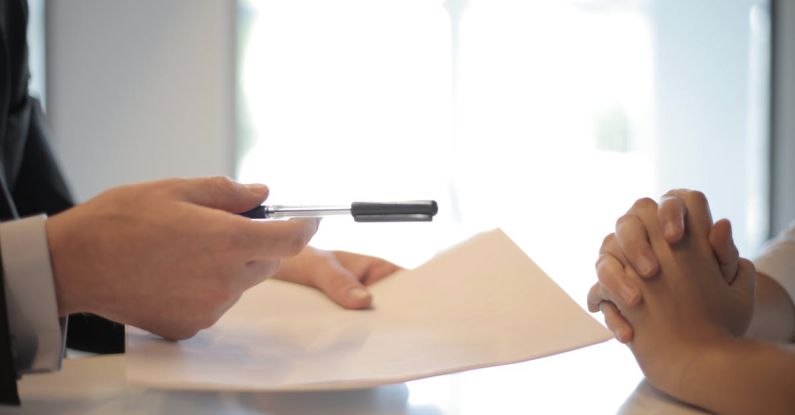 Loans - Crop businessman giving contract to woman to sign