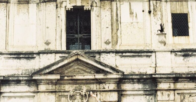 REITs - A woman is jumping in front of a building