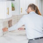 Comparable Sales - Real Estate Agents Checking the Tiles in the Kitchen