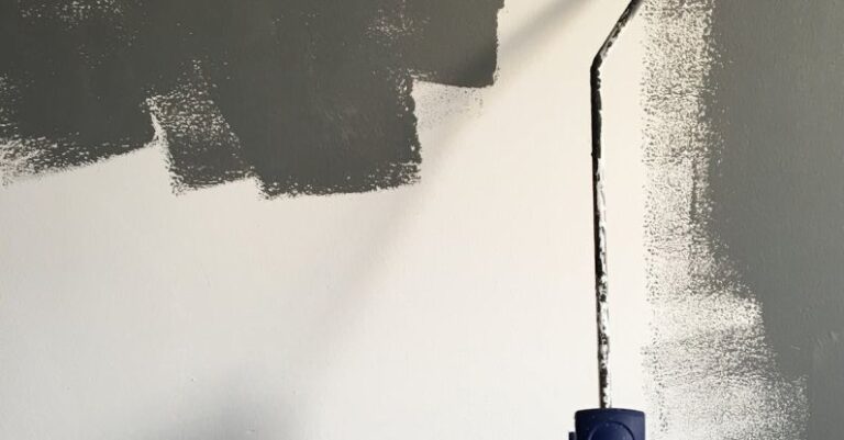 Renovation - Person Holding Paint Roller While Painting the Wall